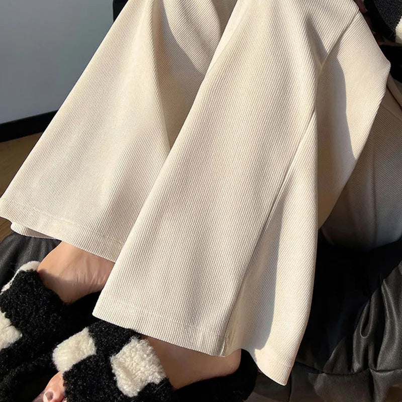 White corduroy wide-leg high-rise pants with pleated front and soft drape