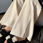 White corduroy wide-leg high-rise pants with pleated front and soft drape