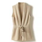 Beige merino wool sweater vest with V-neck and waist tie belt, sleeveless knit.