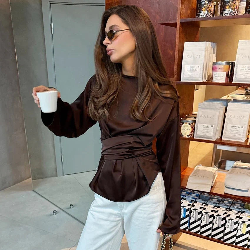 Dark brown satin high-neck blouse with long sleeves and ruched waist with tie