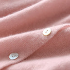 Light pink knit sweater with button placket and small round front buttons detail