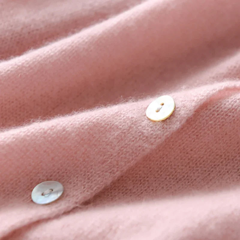 Light pink knit sweater with button placket and small round front buttons detail