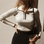 White ribbed knit zip sweater with half-front zipper placket and fitted long sleeves
