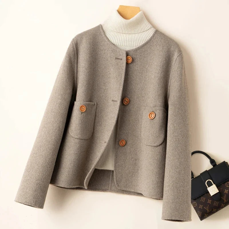 Light gray wool jacket with ribbed turtleneck, button front, and two flap chest pockets