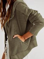 Olive waffle-knit hoodie with long cuffed sleeves and side pocket panel.