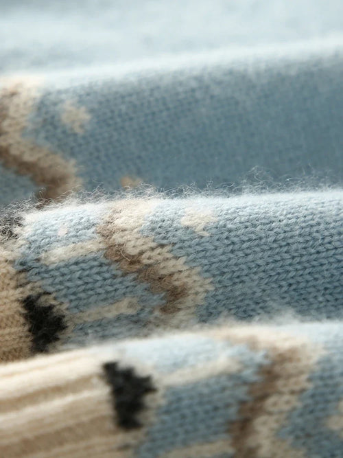 Fair Isle knit pattern swatch in light blue, cream, and dark motifs