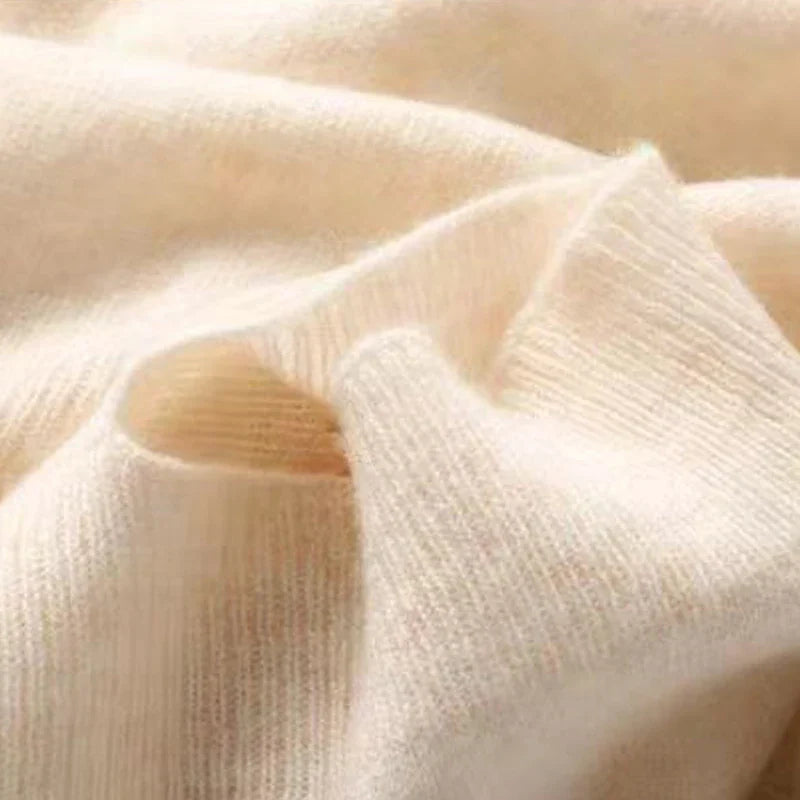 Wool shawl in cream, ribbed knit with soft folds and textured weave detail