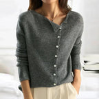 Gray knit sweater with V-neck, front button closure, and ribbed cuffs
