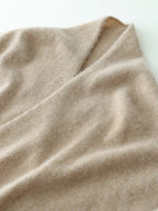 Close-up of beige knit fabric with soft fuzzy texture and smooth drape