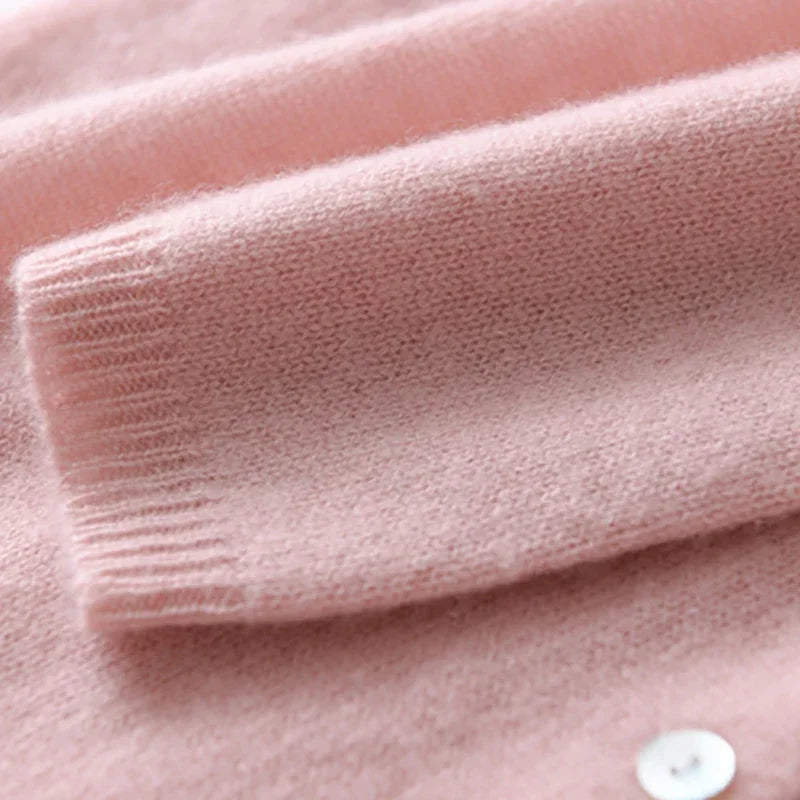 Light pink V-neck knit sweater cuff with ribbed hem and front button placket