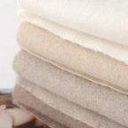 Light beige knit lounge pants waistband and fabric close-up, with soft texture.