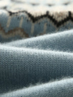 Sky blue sweater cuff with Fair Isle pattern band in cream and dark shapes