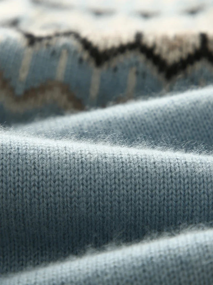 Sky blue sweater cuff with Fair Isle pattern band in cream and dark shapes