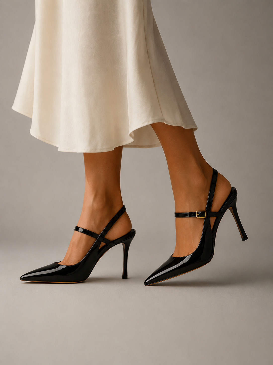Buckle-strap slingback heels in black with pointed toe and slim stiletto heel