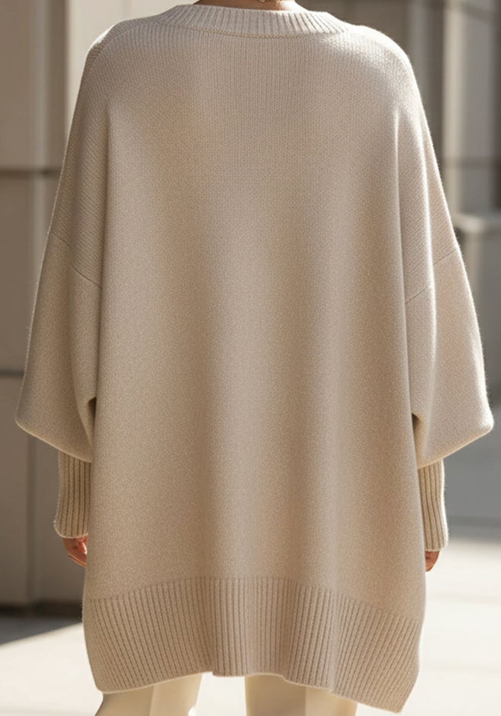 Beige oversized knit sweater with ribbed crew neck and straight, boxy back