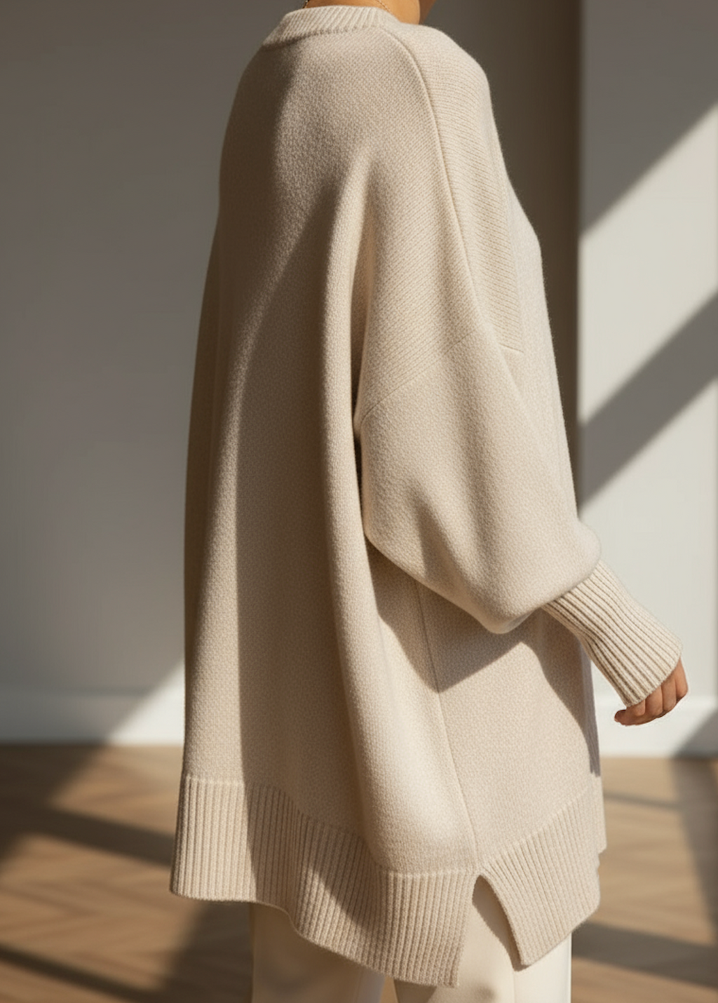 Beige oversized knit sweater with wide batwing sleeves and ribbed hem detail