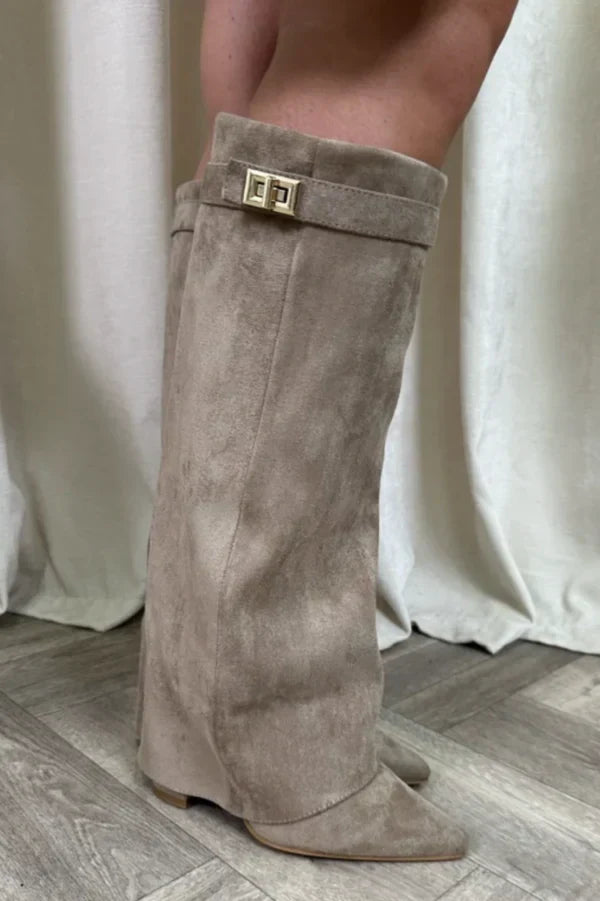 Beige suede tall heeled boots with gold buckle at the top cuff.