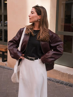 Burgundy zip-up bomber jacket with quilted-like texture and ribbed cuffs