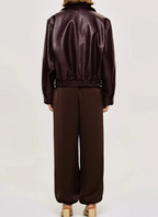 Back view of burgundy zip-up bomber jacket with ribbed hem and cuffs