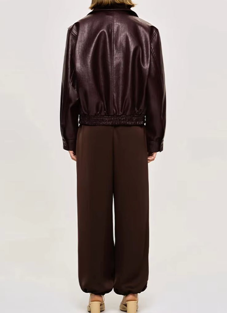Back view of burgundy zip-up bomber jacket with ribbed hem and cuffs