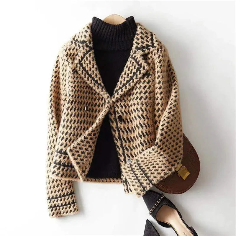 Camel and black houndstooth knit jacket on a hanger, button front and lapels.