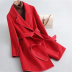 Red overcoat with wide lapels, matching waist belt, and buttoned cuffs