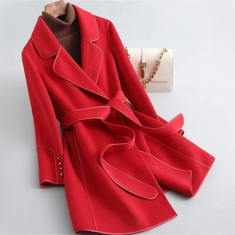 Red overcoat with wide lapels, matching waist belt, and buttoned cuffs