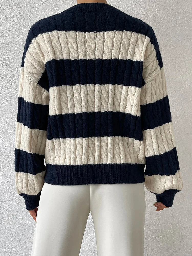Striped cable-knit sweater back view with wide cream and navy bands