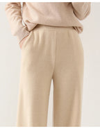 Women’s wide-leg knit pants in cream, close-up of front seams and knit surface