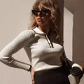 White ribbed knit zip sweater with zip-front placket and fitted long sleeves