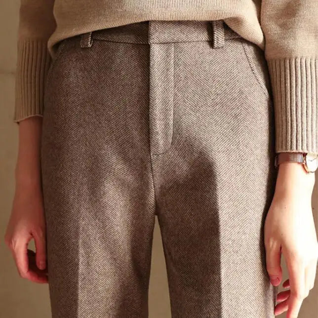 Close-up: camel herringbone straight-leg trousers with front button and belt loops