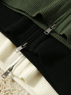 Black zip-up merino wool blend cardigan close-up with metal zipper and ribbed knit