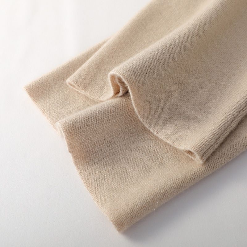 Light beige wide-leg lounge pants cuff and hem detail, soft knit fabric.