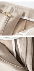 Beige trousers with front zipper opening and belt at the high waist
