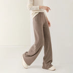 Taupe merino wool wide-leg knit pants with relaxed waist and wide, flowing legs.