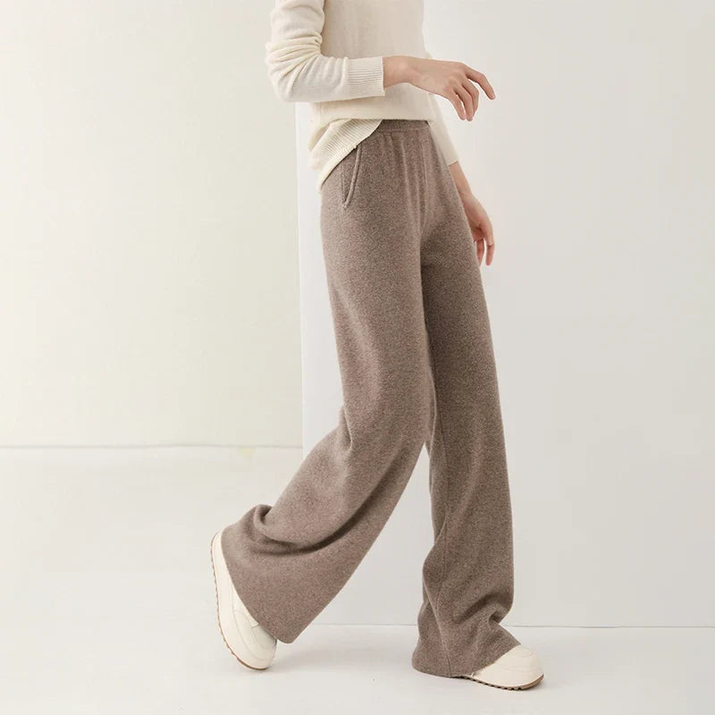 Taupe merino wool wide-leg knit pants with relaxed waist and wide, flowing legs.