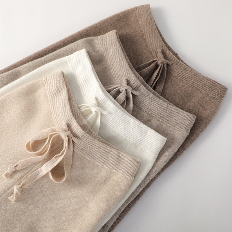 Stack of women’s lounge pants in cream, light beige, and dark beige with drawstring