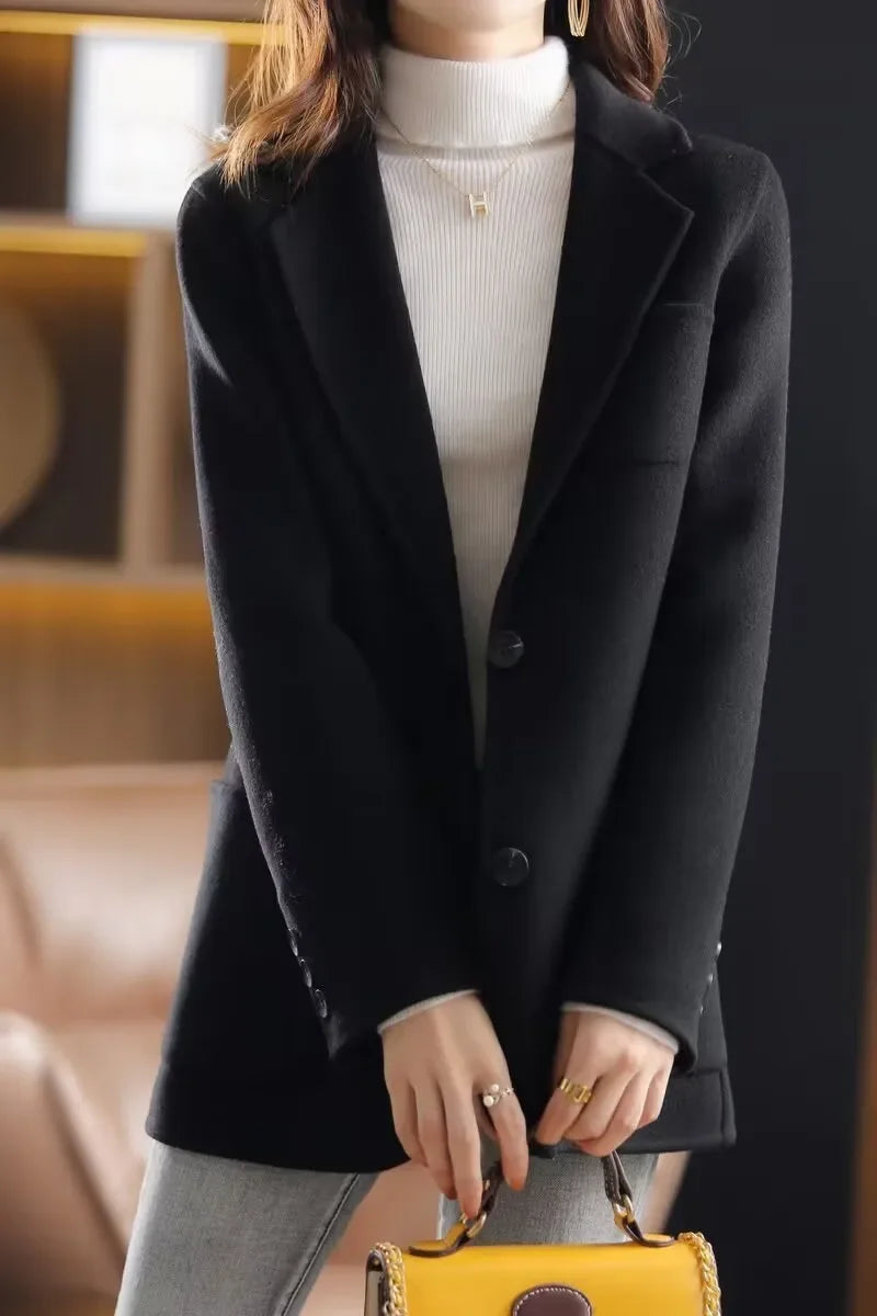 Black wool blazer, notched lapel, button front closure, welt pockets, tailored silhouette