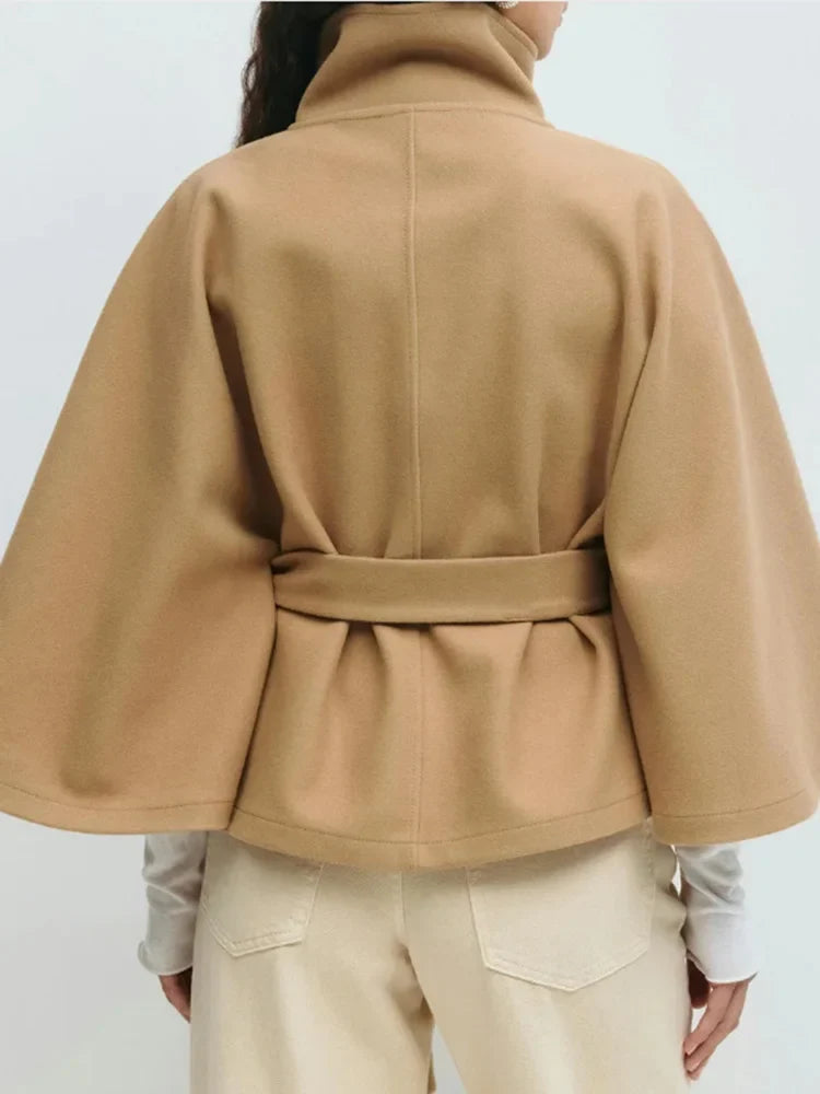 Camel wool-blend cape coat back view with stand collar and waist tie belt