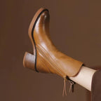 Brown ankle boot with rounded toe, stacked block heel, and side zip