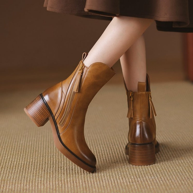 Brown ankle boot showing stacked heel and side zipper with tassel pull