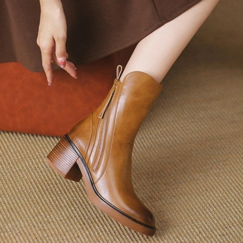 Brown ankle boot with side zipper, tassel detail, and low stacked block heel