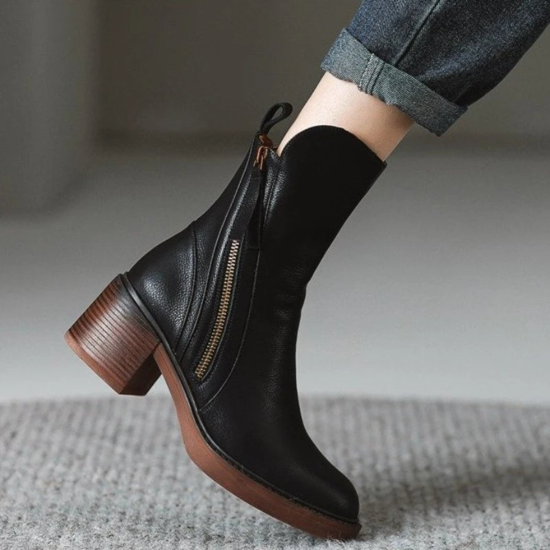 Black ankle boot with side zipper, tassel pull, and stacked block heel