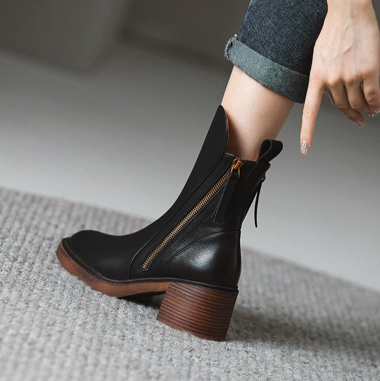 Black ankle boot with side zipper and tassel ties, rounded toe, block heel