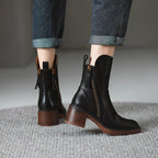 Pair of black ankle boots with side zippers and stacked block heels