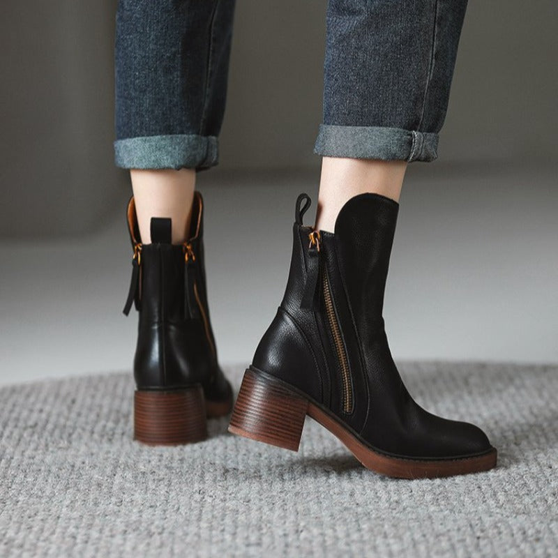Pair of black ankle boots with side zippers and stacked block heels