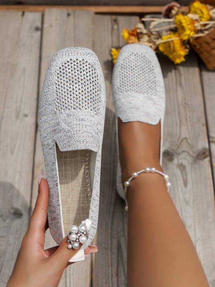 Light gray perforated knit loafer with round toe and slip-on style