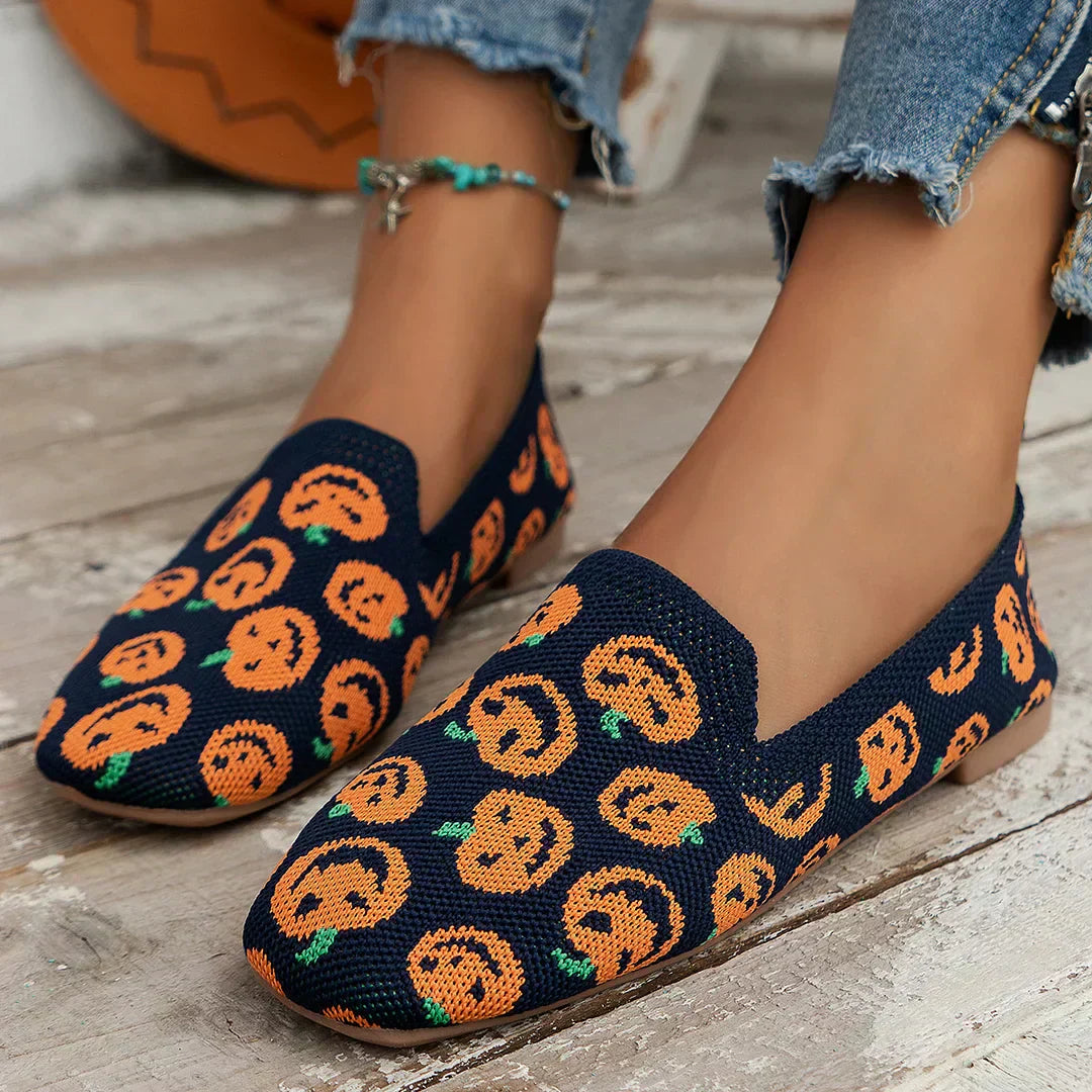 Navy knit slip-on loafer with playful orange patterned toe