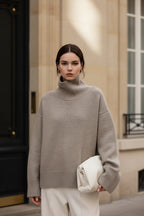 Light gray oversized turtleneck knit sweater with long sleeves and ribbed cuffs