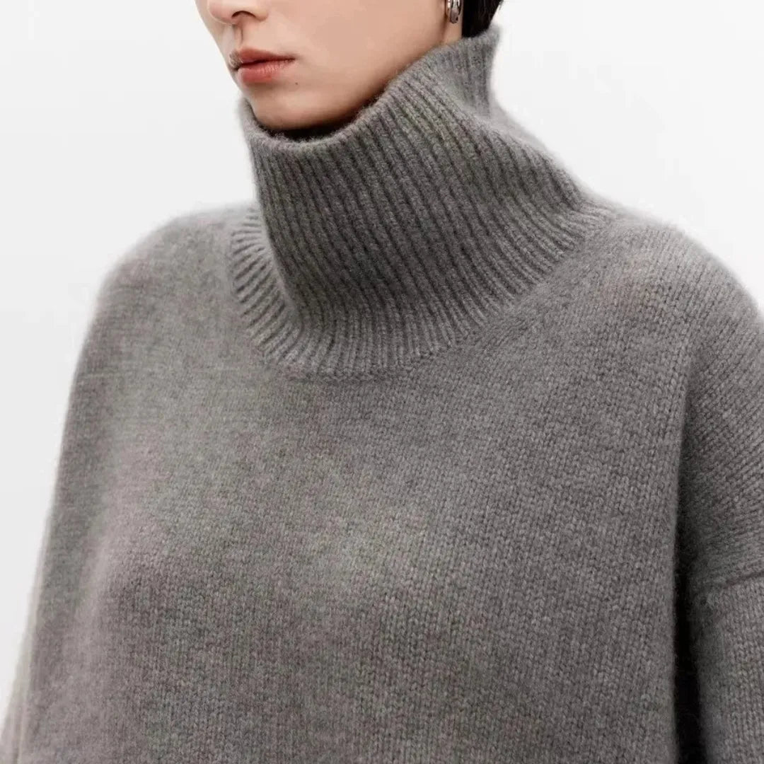 Gray knit turtleneck sweater close-up with thick ribbed collar